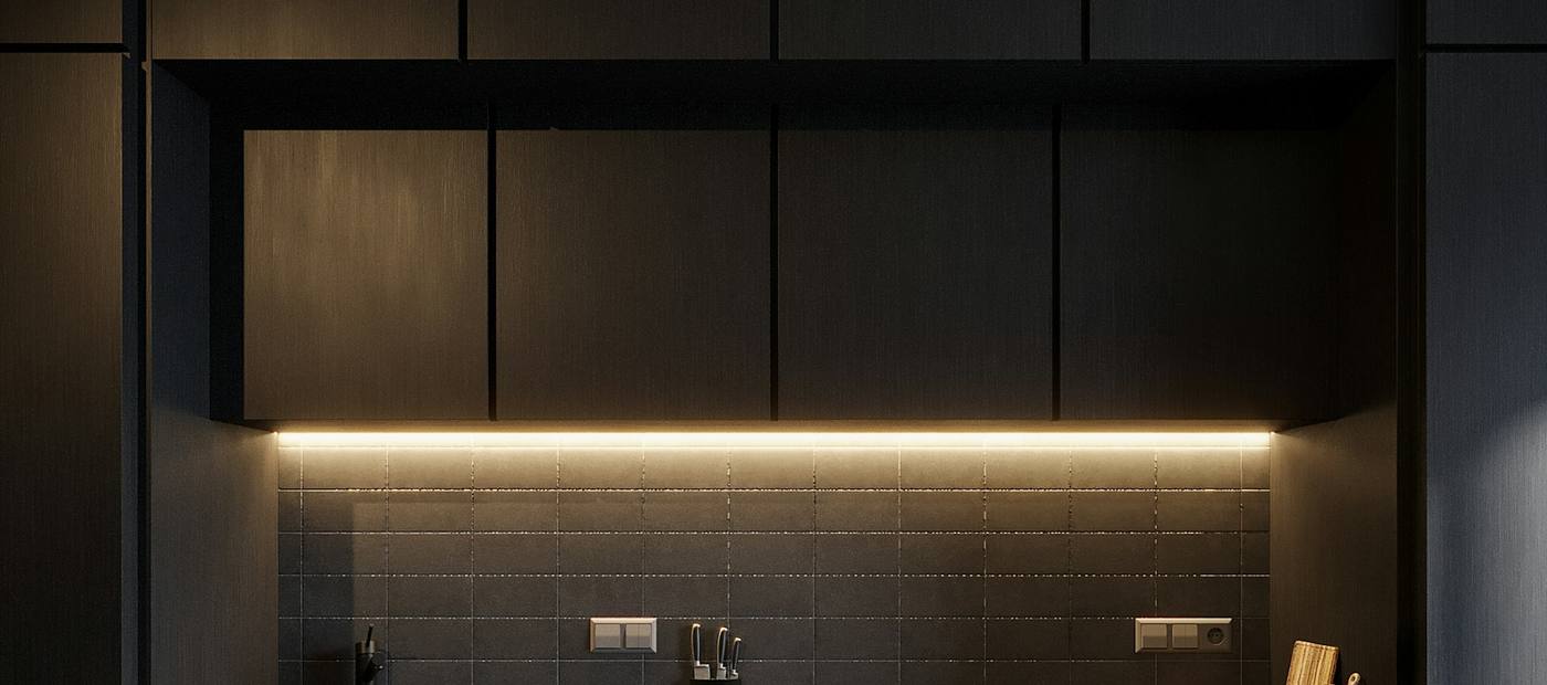 Detail of a dark luxury kitchen with an integrated cooktop